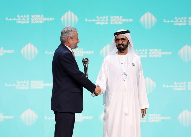 Vice President and Ruler of Dubai, Sheikh Mohammed bin Rashid, presents Dr Ferozuddin Feroz, Public Health Minister of Afghanistan with the best minister award at the World Government Summit in Dubai. Chris Whiteoak / The National