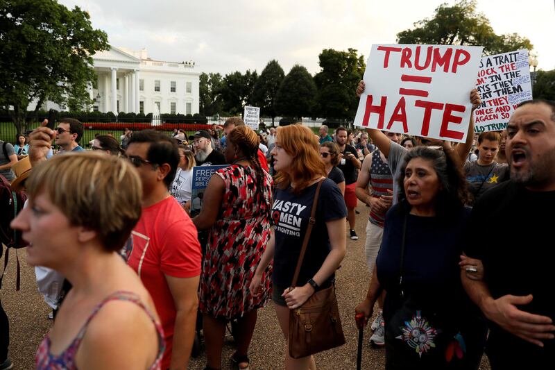 FILE PHOTO: People gather for a vigil in response to the death of a counter-demonstrator at the "Unite the Right" rally in Charlottesville, outside the White House in Washington, DC, U.S. on August 13, 2017.  REUTERS/Jonathan Ernst/File Photo