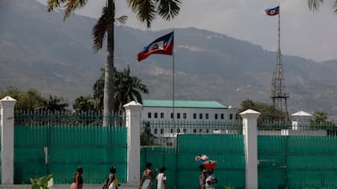 People walk past the National Palace in Port-au-Prince, Haiti. AP