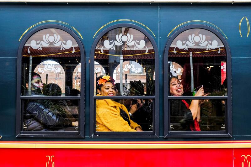 Women sit on a trolley as the Mexican-American community of Pilsen celebrate Day of the Dead with celebrations throughout their neighbourhood in Chicago. Reuters