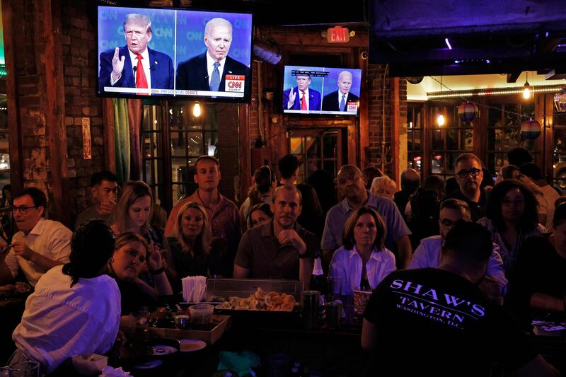 People watch the debate at a party at a bar in Washington. AFP