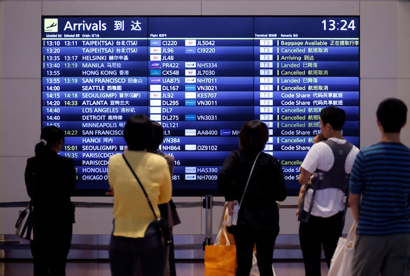 People wait for arriving travellers at Haneda International Airport. Reuters