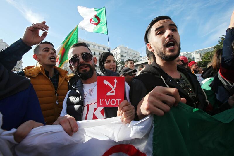 A man holds a sign reading" No vote", during a protest rejecting the presidential election in Algiers, Algeria December 11, 2019. REUTERS/Ramzi Boudina