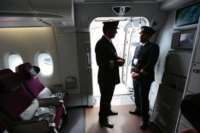 Flight crew stand in the passenger access door of the A380. Jason Alden / Bloomberg