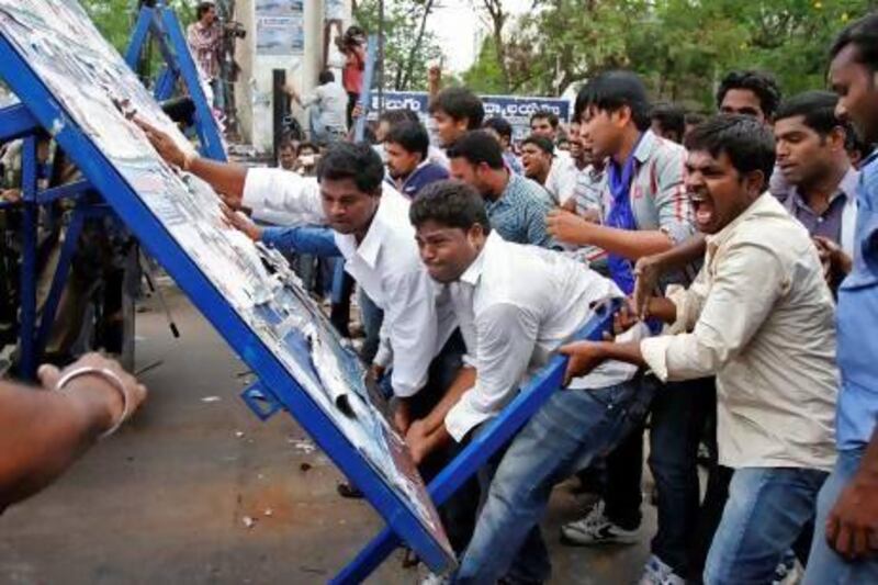 Pro-Telangana supporters overturn a barricade during a protest rally in the southern Indian city of Hyderabad.