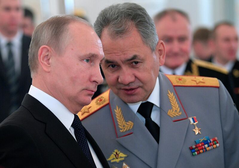 FILE In this file photo taken on Thursday, Dec. 28, 2017, Russian President Vladimir Putin, left, and Defence Minister Sergei Shoigu talk during an awards ceremony for troops who fought in Syria, in the Kremlin, in Moscow, Russia. Experts say Putin isnâ€™t necessarily dictating every Russian influence campaign abroad. Some accused of meddling in the 2016 U.S. elections appear to be ambitious individuals taking the initiative based on signals from the presidential entourage. (Alexei Druzhinin, Sputnik, Kremlin Pool Photo via AP, File)