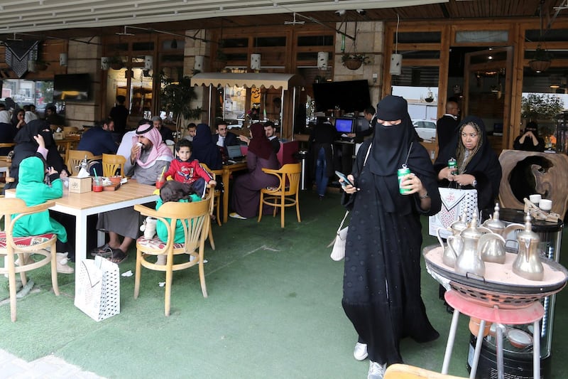 Men and women eat food in a restuarant in Riyadh. Reuters