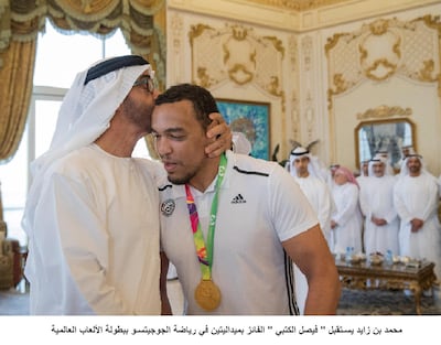 ABU DHABI, UNITED ARAB EMIRATES - July 31, 2017: HH Sheikh Mohamed bin Zayed Al Nahyan, Crown Prince of Abu Dhabi and Deputy Supreme Commander of the UAE Armed Forces (L), receives Faisal Al Ketbi (R), who recently won a gold medal in Jiu-Jitsu at the World Games in Poland. Seen during a Sea Palace barza. 
( Mohamed Al Hammadi / Crown Prince Court - Abu Dhabi )
---