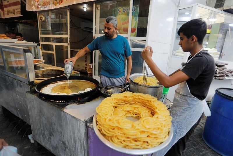 Iraqi workers prepare traditional sweets for sale during Ramadan at a shop in Baghdad, Iraq. Reuters