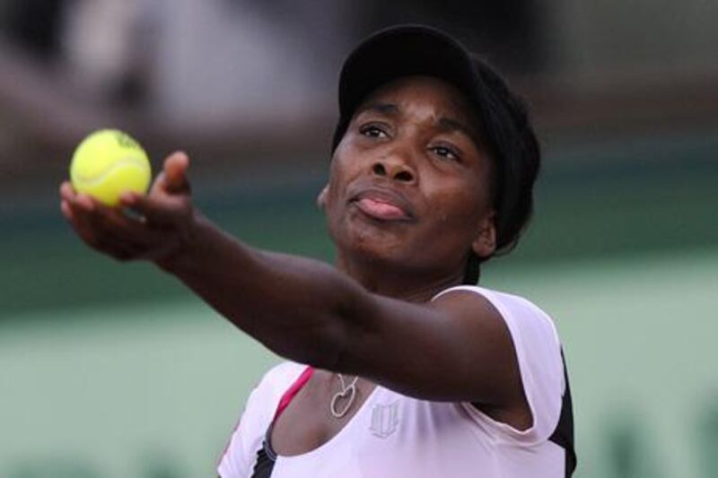 US Venus Williams serves to Argentina's Paula Ormaechea during their Women's Singles 1st Round tennis match of the French Open tennis tournament at the Roland Garros stadium, on May 27, 2012 in Paris.    AFP PHOTO / PASCAL GUYOT

