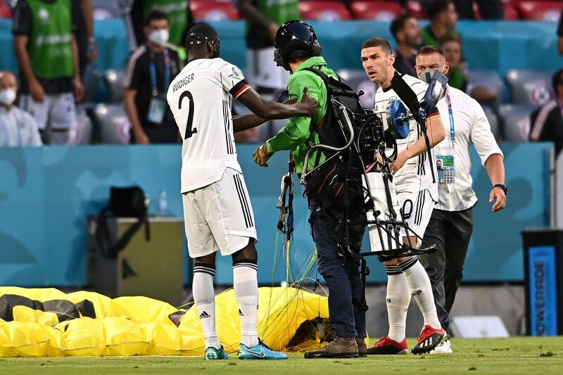 The protester is helped up by German footballer Antonio Rudiger. Getty Images