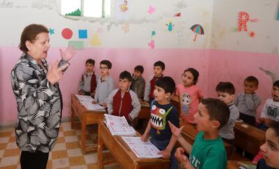 Antoinette Makh, instructs her pupils in the Aramic language at a school in the Syrian mountain village of Maalula, in the Damascus region on May 13, 2019. Today, "80 percent of Maalula's inhabitants don't speak Aramaic, and the remaining 20 percent are over 60 years old," said an expert.
Etched out in the cliff face, and full of churches, convents, and monasteries, Maalula is considered a symbol of Christian presence in the Damascus region. 
 / AFP / LOUAI BESHARA
