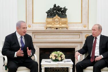 Russian President Vladimir Putin sits with Israeli Prime Minister Benjamin Netanyahu during a meeting at the Kremlin. EPA, pool