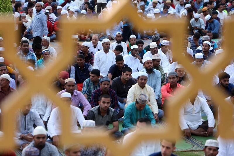 Muslim men gather outside a mosque in Muscat on the first day of Eid Al Adha. AFP