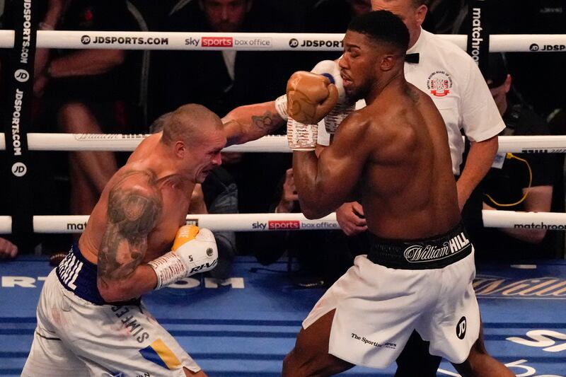 Oleksandr Usyk throws a punch at Anthony Joshua. AP