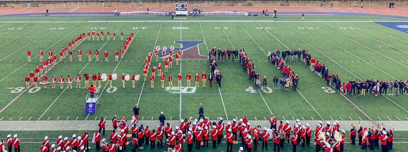 UPenn band members and alumni spell out Penn during their homecoming American football game.