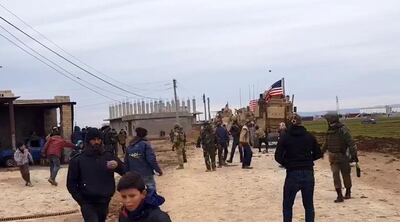 A handout image grab obtained from the official Syrian Arab News Agency (SANA) on February 12, 2020, allegedly shows men and US soldiers surrounding US military vehicles in the town of Kherbit Amo near the northeastern Syrian city of Qamishly.  The US-led coalition said its forces in northeast Syria today confronted gunmen with live fire after one of its patrols came under attack near the city of Qamishli.
According to the coalition forces spokesman Myles Caggins, the patrol encountered a checkpoint occupied by pro-Syrian regime forces and came under small arms fire from unknown individuals and in self defense the coalition troops returned fire. 
 -  == RESTRICTED TO EDITORIAL USE - MANDATORY CREDIT "AFP PHOTO / HO / SANA" - NO MARKETING NO ADVERTISING CAMPAIGNS - DISTRIBUTED AS A SERVICE TO CLIENTS ==
 / AFP / SANA / STRINGER /  == RESTRICTED TO EDITORIAL USE - MANDATORY CREDIT "AFP PHOTO / HO / SANA" - NO MARKETING NO ADVERTISING CAMPAIGNS - DISTRIBUTED AS A SERVICE TO CLIENTS ==
