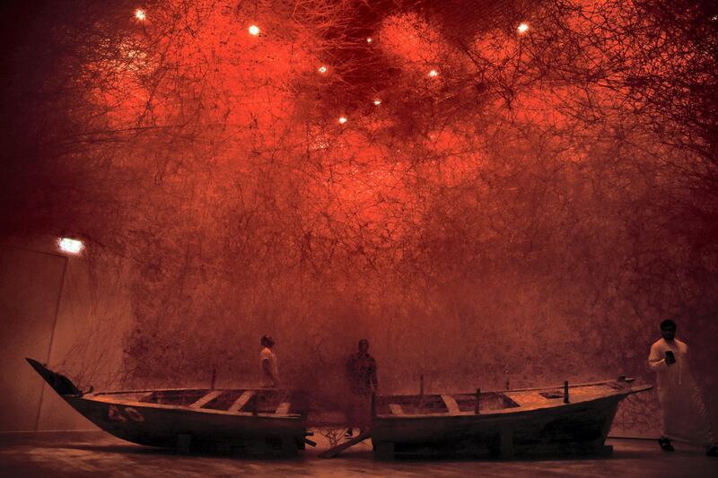 People take a look at the "Departure" installation by Japanese artist Chiharu Shiota at the Jameel Arts Centre in Dubai, United Arab Emirates, Friday, April 26, 2019. (Shruti Jain/The National)