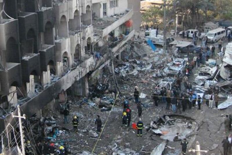 Iraqi security forces inspect a crater caused by a car bomb attack in the neighborhood of Karrada in Baghdad, Iraq, Thursday, Dec. 22, 2011. A series of blasts Thursday morning in Baghdad killing and wounding scores of people in a coordinated attack designed to wreak havoc across the Iraqi capital. (AP Photo/Hadi Mizban)