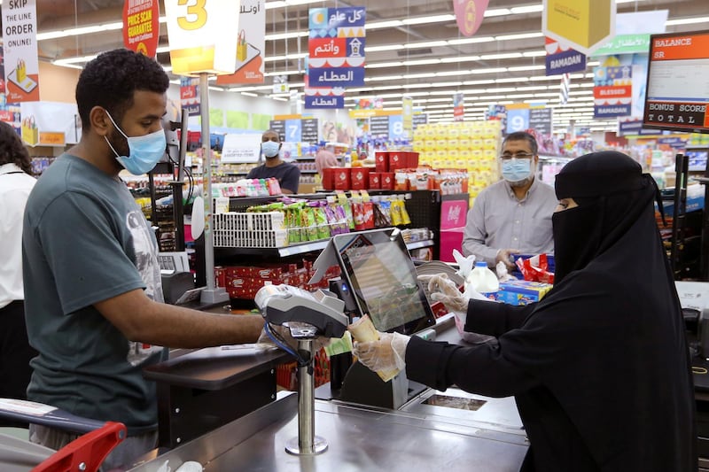 People wearing protective face masks and gloves shop at a supermarket in Riyadh, Saudi Arabia. Reuters