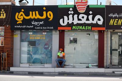 RAK, United Arab Emirates - Reporter: N/A: A waiter wearing a face mask and gloves waits for custom in Ras Al Khaimah. Tuesday, March 31st, 2020. Ras Al Khaimah. Chris Whiteoak / The National