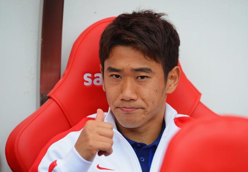 Shinji Kagawa of Manchester United gives a thumbs-up from the bench prior to United's Premier League match against Sunderland on Sunday. Michael Regan / Getty Images / August 24, 2014