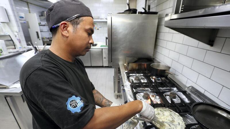 Chef Marcelo Perez Jr cooks up a meal at Cycle Hub, which already discloses the calorie content of their food to customers. Chris Whiteoak / The National