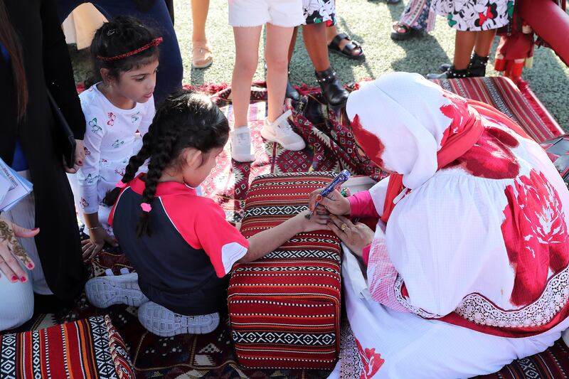 Pupils at a henna tent at Gems Wellington Academy Al Khail 