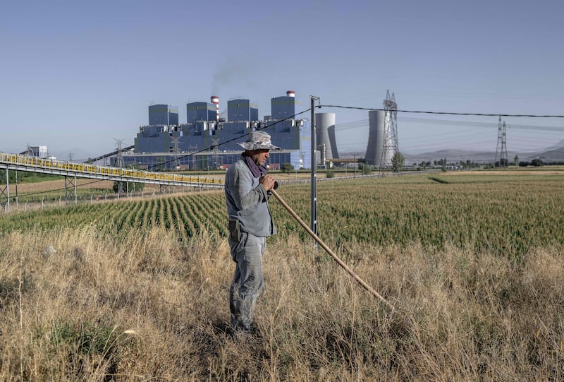 Turkish farmer Yusuf Avci works his field close to the Afsin power plant in Kahramanmaras province