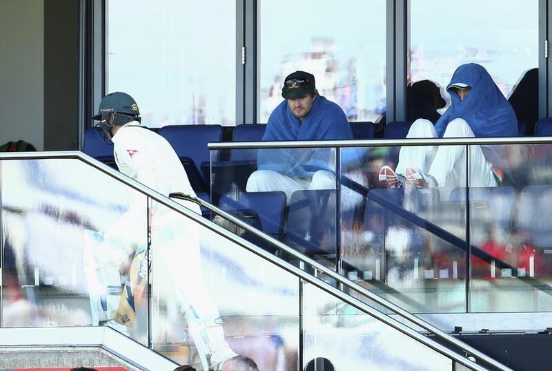 Michael Clarke walks back to the pavilion as Shane Watson and Brad Haddin look on. Ryan Pierse / Getty Images