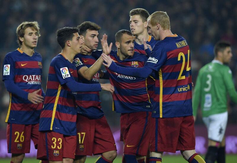 Barcelona player Munir El Haddadi, third left, celebrates with Sergi Samper, left, Aitor Cantalapiedra, second left, Sandro Ramirez, third right, Gerard Gambau, second right and Jeremy Mathieu, right, after scoring one of his two goals in the Copa del Rey on Wednesday. Lluis Gene / AFP