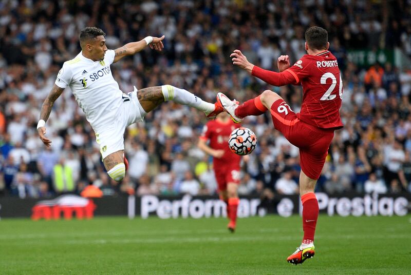 Leeds United midfielder Raphinha battles for the ball with Liverpool defender Andrew Robertson. AFP