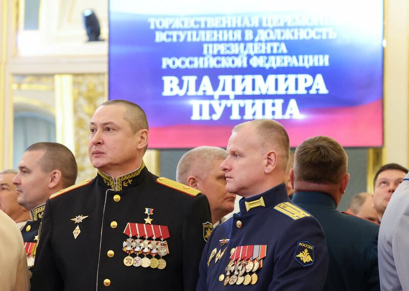 Military officers involved in Russia's campaign in Ukraine wait before the ceremony. Reuters