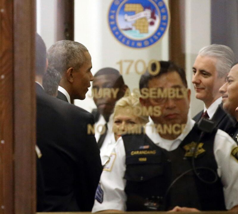 Former President Barack Obama arrives for jury duty in the Daley Center on Wednesday, Nov. 8, 2017, in Chicago. Obama is in line to be paid the same $17.20 a day that others receive for reporting for jury duty. (Kevin Tanaka/Sun Times via AP)