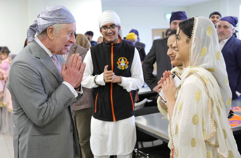 King Charles makes the traditional namaste gesture on a visit to the Guru Nanak Gurdwara in Luton. AFP