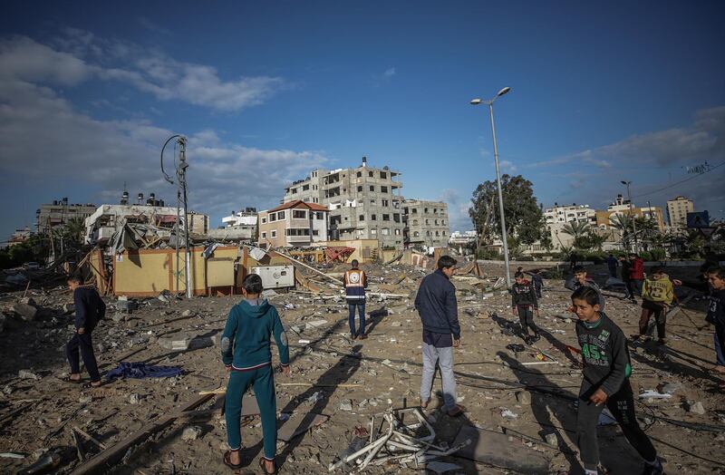 Palestinians inspect a destroyed office of Hamas. EPA