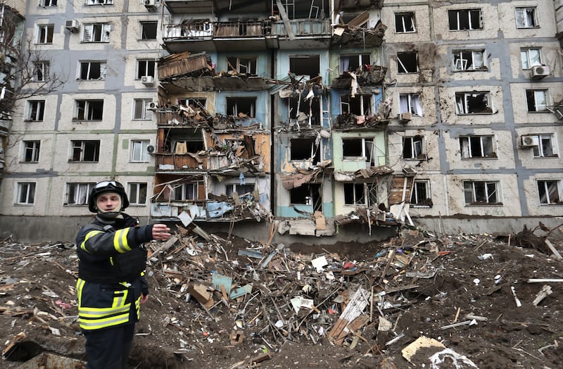 Ukrainian rescuers at the scene of a missile strike near a residential building, in Zaporizhzhia. EPA