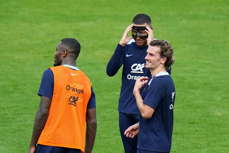 France's Antoine Griezmann, right, with Kylian Mbappe, and Marcus Thuram during a training session. AP 