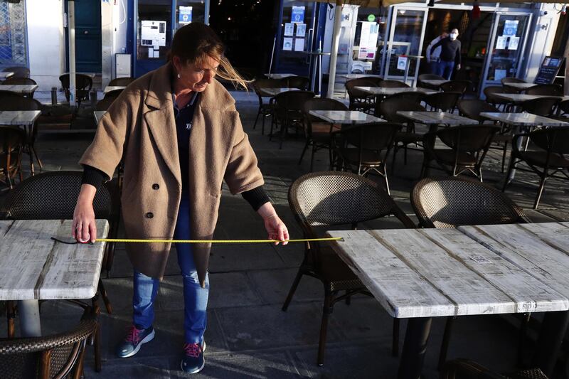 A waiter makes sure tables are correctly distanced in Montpellier. EPA
