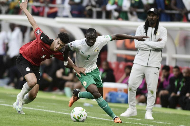 Senegal's Saliou Ciss battles with Emam Ashour of Egypt. AFP