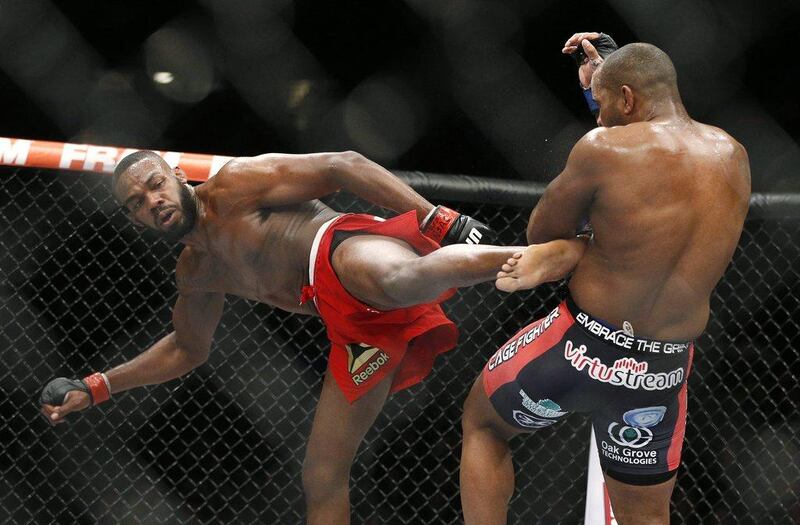 Jon Jones kicks Daniel Cormier during their fight on Saturday at UFC 182. John Locher / AP