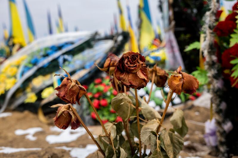 Dead roses on a grave in the military section of a cemetery in Kharkiv, Ukraine. Getty 