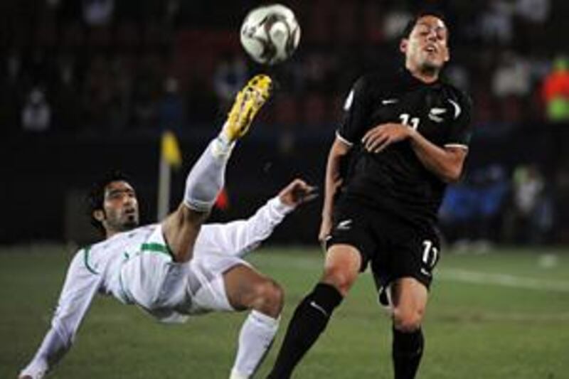 Iraqi defender Mohammed Ali Kareem fights for the ball with New Zealand Leo Bertos during the Fifa Confederations Cup.