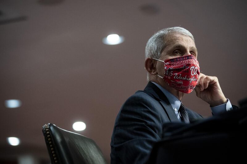 Anthony Fauci, director of the National Institute of Allergy and Infectious Diseases, wears a Washington Nationals protective mask while listening during a Senate Health, Education, Labor and Pensions Committee hearing in Washington, D.C., U.S., on Tuesday, June 30, 2020. The U.S. government's top infectious disease specialist said he's "quite concerned" about the spike in cronavirus cases in Florida, Texas, Arizona and California. Photographer: Al Drago/Bloomberg