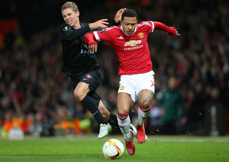 MANCHESTER, ENGLAND - FEBRUARY 25:  Memphis Depay of Manchester United and Andre Romer of FC Midtjylland compete for the ball during the UEFA Europa League Round of 32 second leg match between Manchester United and FC Midtjylland at Old Trafford on February 25, 2016 in Manchester, United Kingdom.  (Photo by Alex Livesey/Getty Images)