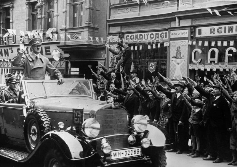 1st October 1938:  Adolf Hitler (1889 - 1945) is greeted with the Nazi salute as he heads a convoy through Sudetenland, which had become part of the Third Reich after the Munich Pact.  (Photo by Topical Press Agency/Getty Images)