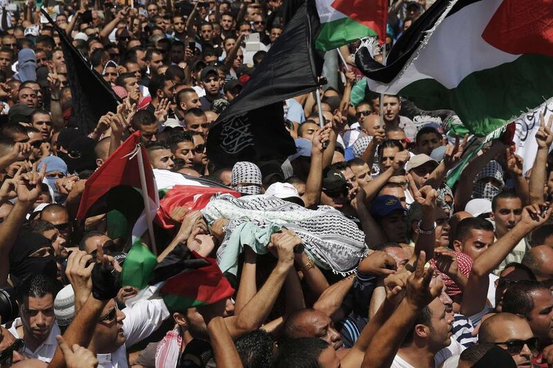 Palestinians carry the body of 16-year-old Mohammed Abu Khudair during his funeral in Shuafat, an Arab suburb of Jerusalem, on Saturday. Finbarr O'Reilly / Reuters