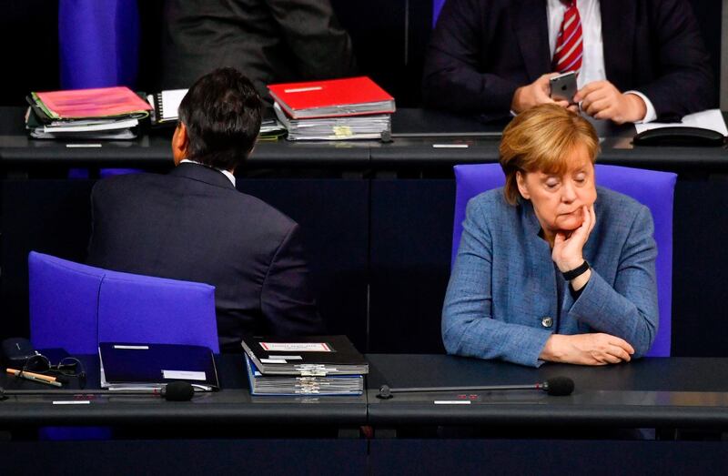 German chancellor Angela Merkel and vice chancellor and foreign minister Sigmar Gabriel take their seats to attend a plenary session at the Bundestag in Berlin. John Mac Dougall / AFP Photo