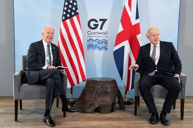 US President Joe Biden, left, poses for a photo with Britain's Prime Minister Boris Johnson, during their meeting ahead of the G7 summit in Cornwall, Britain, Thursday June 10, 2021. AP