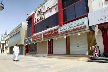 A Saudi man walks next to a row of closed shops in Riyadh. Reuters